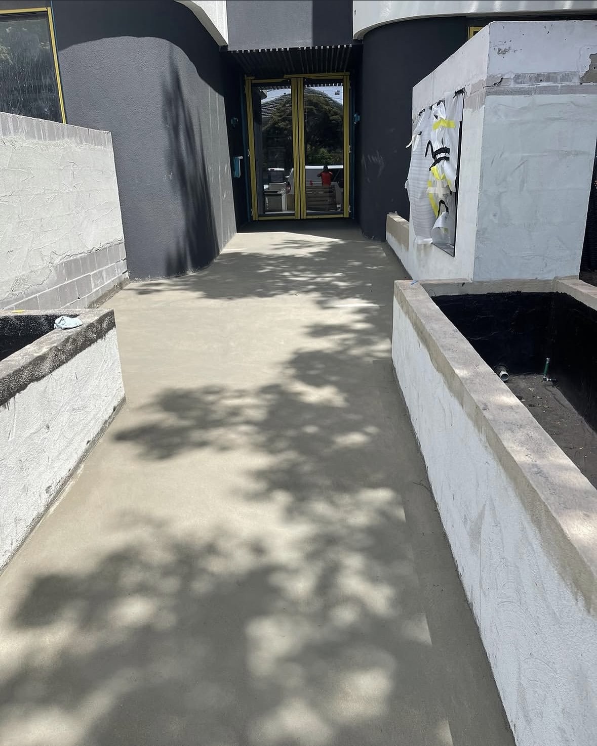 Screed laid through an entry passage, ready for its next finish